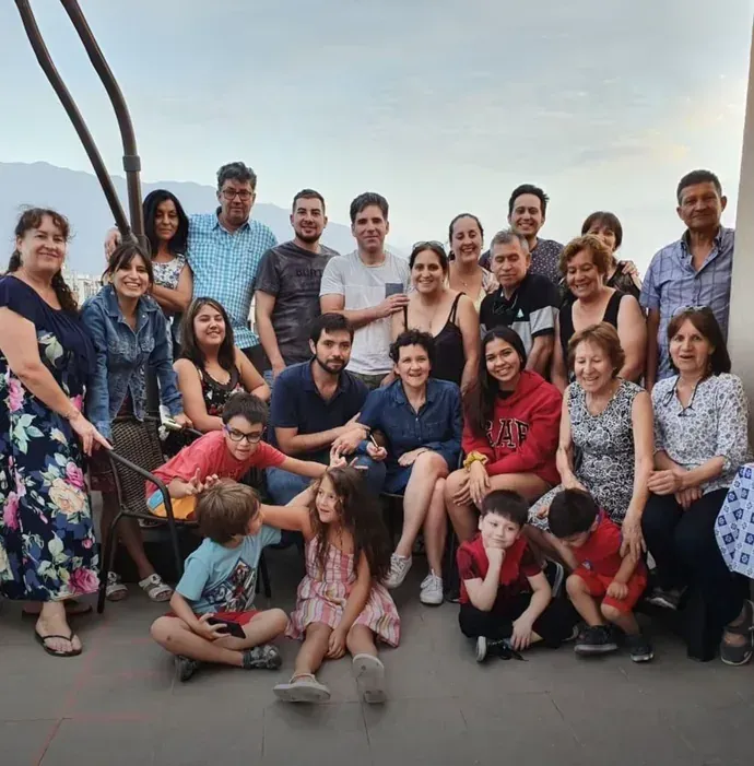Macarena’s family gathered on a terrace, more than twenty people of all ages posing together.